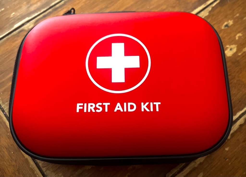 a closeup view of a red first aid kit laying on a table
